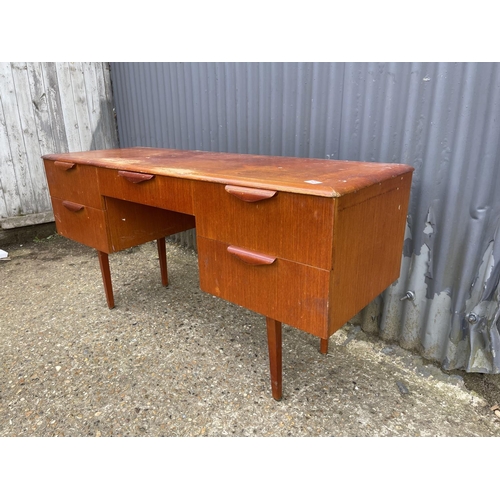 45 - A teak five draw desk