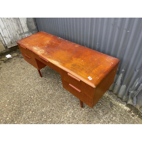 45 - A teak five draw desk