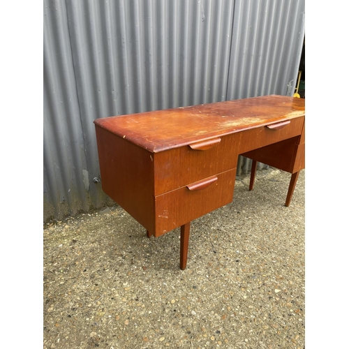 45 - A teak five draw desk