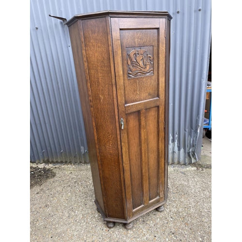 70 - An oak single door wardrobe with carved panel to the door 85x44x189