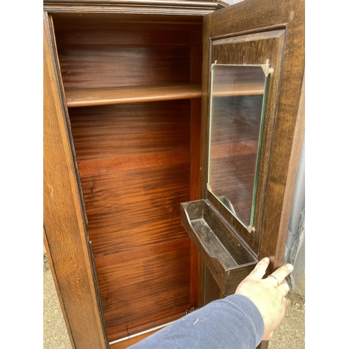 70 - An oak single door wardrobe with carved panel to the door 85x44x189