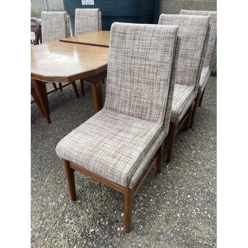 88 - A mid century extending rosewood dining table together with a set of six mid century chairs with ori... 