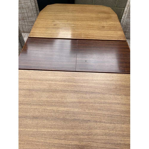 88 - A mid century extending rosewood dining table together with a set of six mid century chairs with ori... 