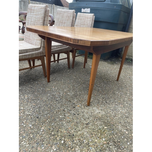 88 - A mid century extending rosewood dining table together with a set of six mid century chairs with ori... 