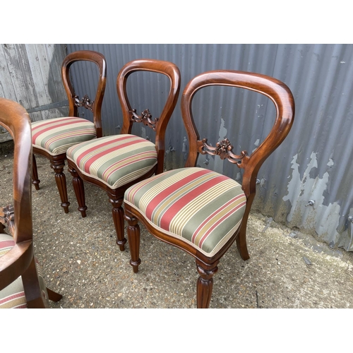 89 - A set of five reproduction mahogany balloon back chairs (inc. 2 carvers)