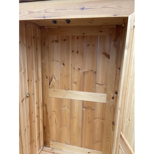 96 - A solid pine double wardrobe with drawer 106x 56 x 200