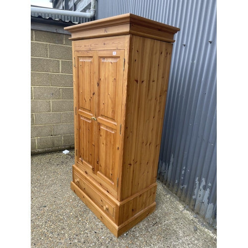 96 - A solid pine double wardrobe with drawer 106x 56 x 200