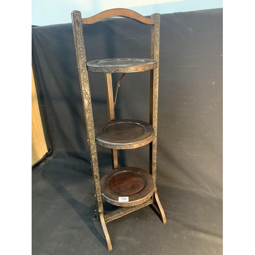 731 - A carved Mahogany three tier cake stand with blind fret decoration