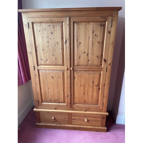 13 - A solid pine double wardrobe by Lincoln pine Furniture with two doors over two drawer base (currentl... 