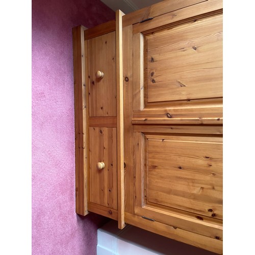 13 - A solid pine double wardrobe by Lincoln pine Furniture with two doors over two drawer base (currentl... 