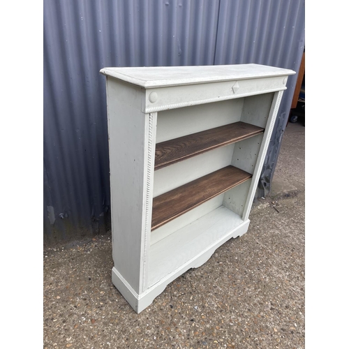 11 - An oak open bookcase painted green 100cm wide