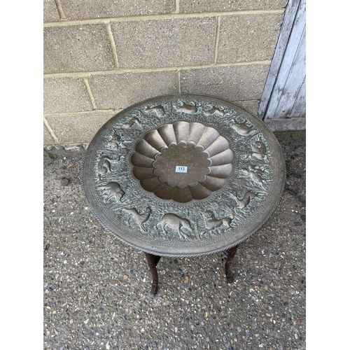 113 - An Brass tray top table raised on oriental hardwood folding base