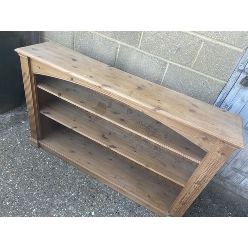 116 - A pine open fronted bookcase 156cm wide