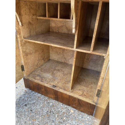 121 - A deco style walnut workstation cabinet with burr walnut fitted interior, brown leather top writing ... 