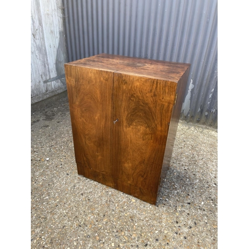 121 - A deco style walnut workstation cabinet with burr walnut fitted interior, brown leather top writing ... 