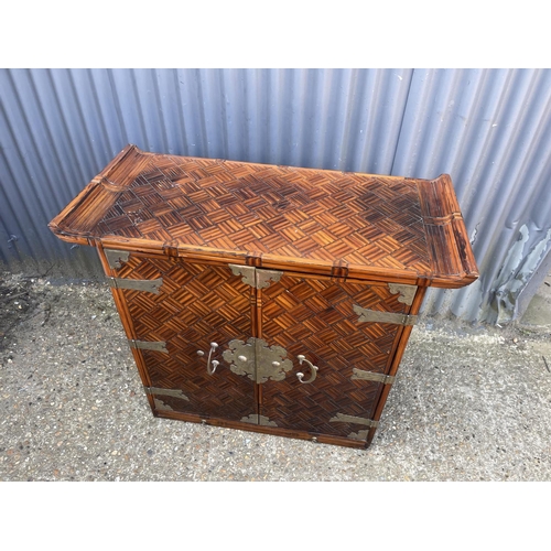 126 - An oriental Style two door sideboard 97x45x86