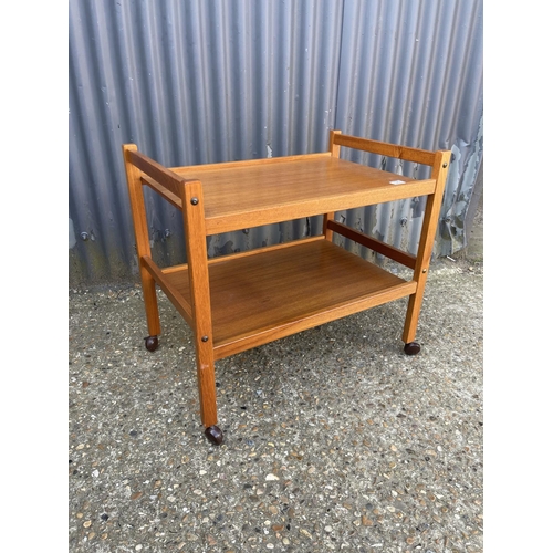 129 - A danish teak tea trolley, labelled MADE IN DENMARK