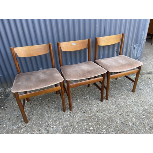 130 - Three teak dining chairs