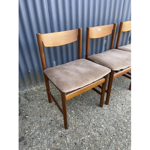 130 - Three teak dining chairs