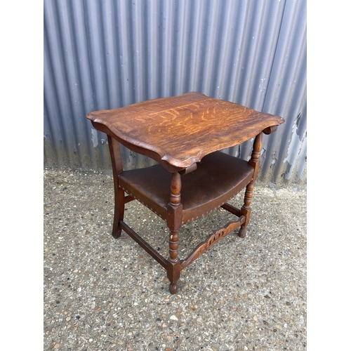 134 - An oak fold over monks bench / table with leather seat