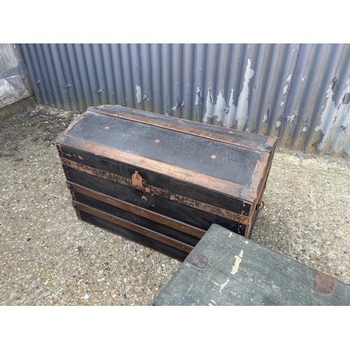 135 - A vintage dome top trunk together with a wooden trunk