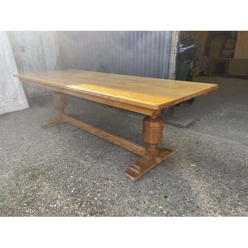 136 - A large light oak refectory style dining table together with a set of 12 upholstered oak framed dini... 