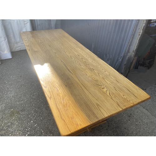 136 - A large light oak refectory style dining table together with a set of 12 upholstered oak framed dini... 