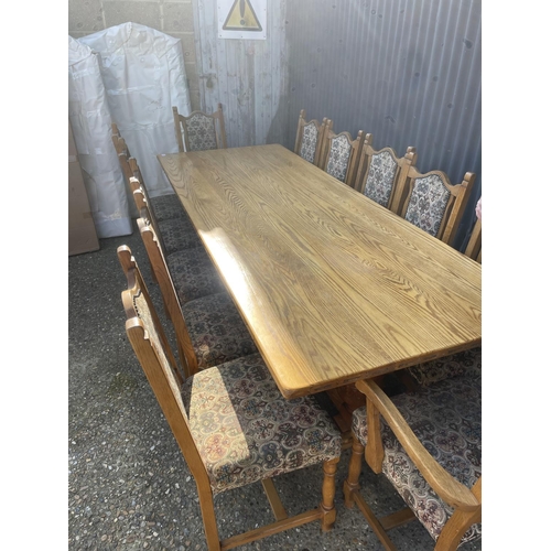 136 - A large light oak refectory style dining table together with a set of 12 upholstered oak framed dini... 