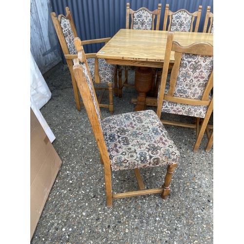 136 - A large light oak refectory style dining table together with a set of 12 upholstered oak framed dini... 