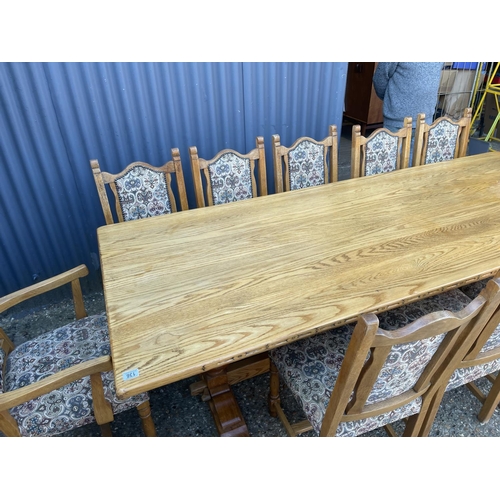 136 - A large light oak refectory style dining table together with a set of 12 upholstered oak framed dini... 