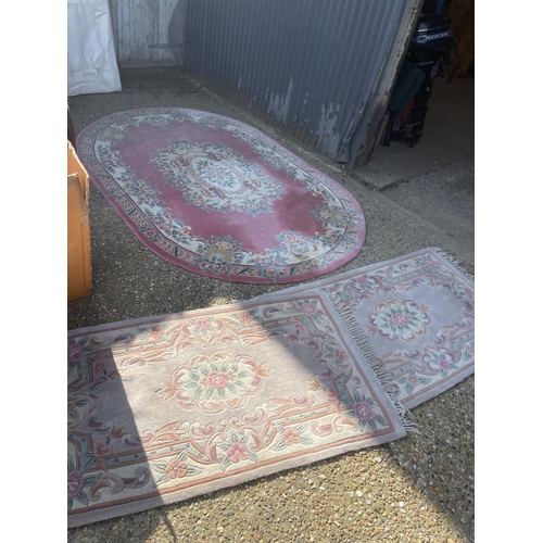 144 - A very large pink chinese rug together with two other chinese rugs