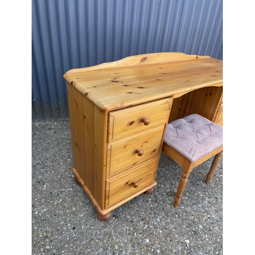 146 - A six drawer pine desk with stool