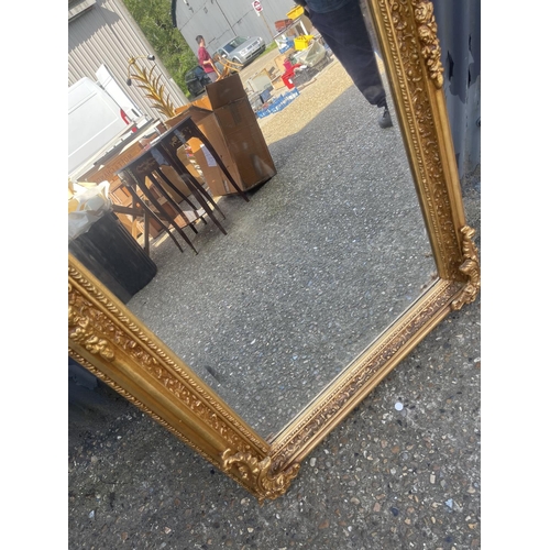 152 - A large ornate gold gilt wall mirror 80x160 cms