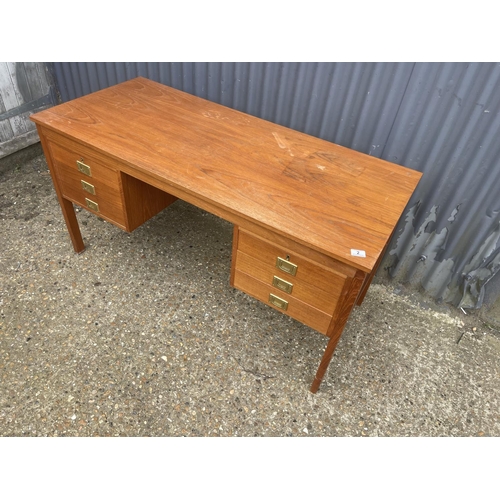 2 - A danish style teak desk with six drawers, each with brass military handles 136x60x70