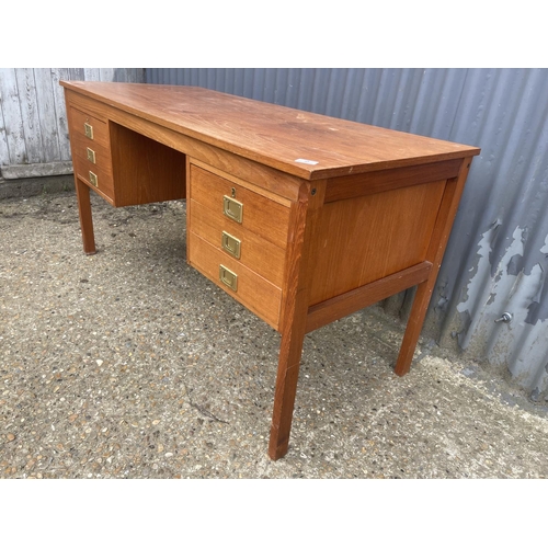 2 - A danish style teak desk with six drawers, each with brass military handles 136x60x70