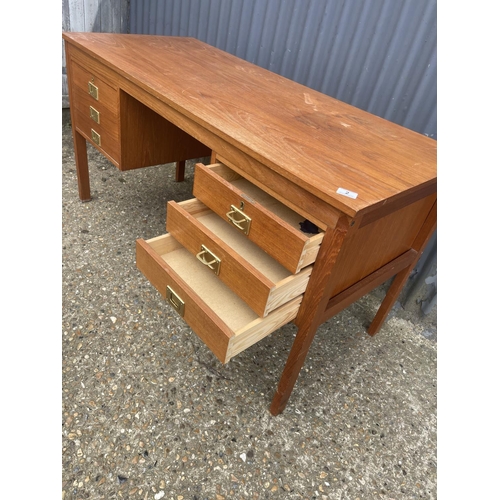 2 - A danish style teak desk with six drawers, each with brass military handles 136x60x70