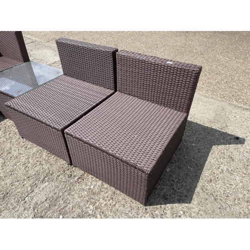 23 - A rattan five piece modular garden seat set