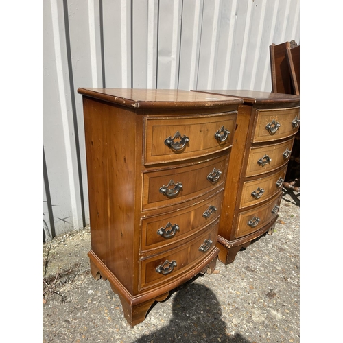 24 - A pair of yew four drawer bedside chests of drawers