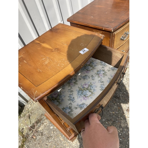 24 - A pair of yew four drawer bedside chests of drawers