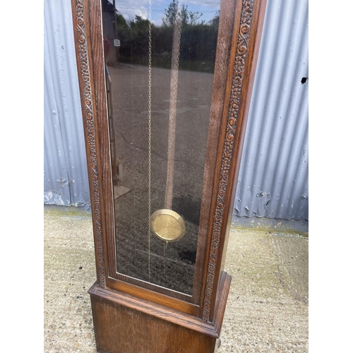 31 - A deco style oak cased longcase clock by BRAVINGTONS with pendulum and three weights