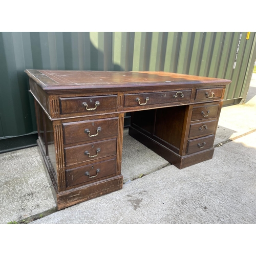 314 - An Edwardian mahogany twin pedestal desk with brown leather top