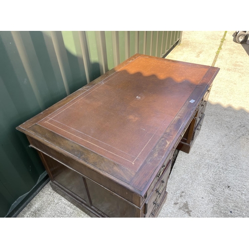 314 - An Edwardian mahogany twin pedestal desk with brown leather top