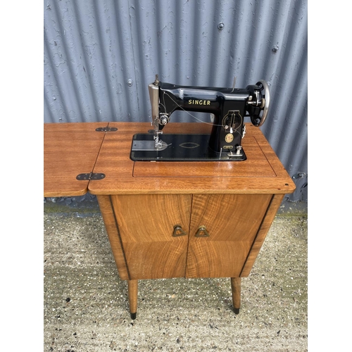 33 - A walnut cased singer sewing machine table