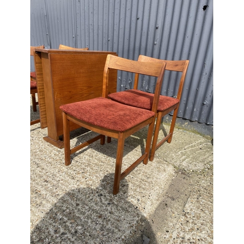 34 - A danish style teak drop leaf dining table together with four teak dining chairs