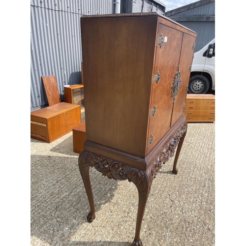 37 - A large walnut cocktail drinks cabinet 105x45x156.