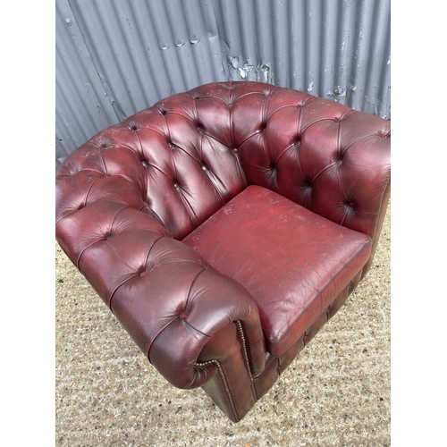 39 - An oxblood red leather chesterfield club armchair