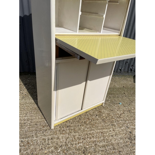 40 - A vintage yellow and white painted kitchen cabinet with drop down front