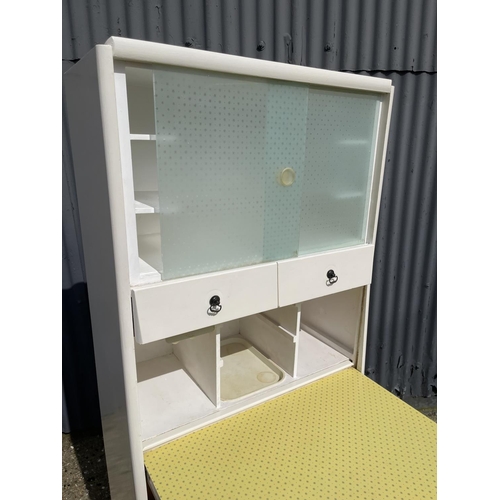 40 - A vintage yellow and white painted kitchen cabinet with drop down front