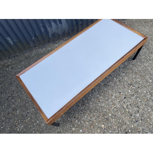 49 - A mid century teak coffee table with white formica top 127x57