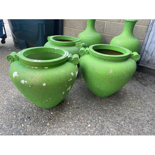 52 - A collection of five large green plastic urns / planters